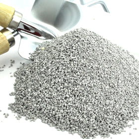 Applying Jobe's Organics soil acidifier to soil during planting