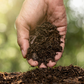 Jobe's Organics compost starter sprinkled into an outdoor pile