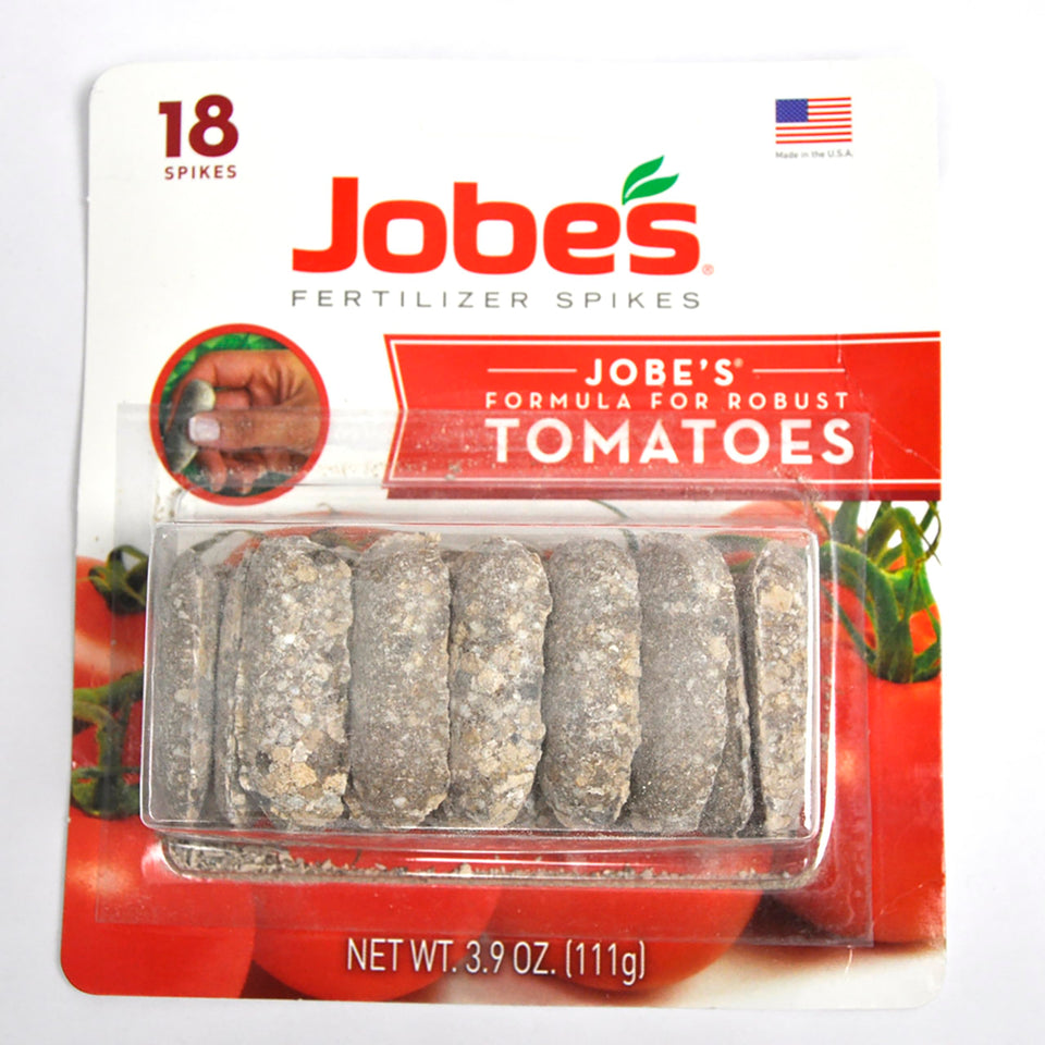 Jobe's Tomato Fertilizer Spikes placed around a tomato plant for root feeding.