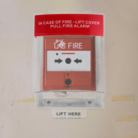 jojofuny protective guard enveloping a fire alarm pull point