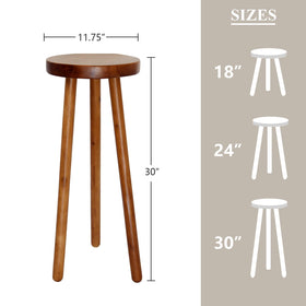 JOLLYMER teak stand with white-dipped legs adds a playful accent