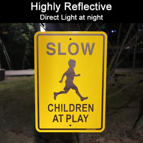 Jowanyo Slow Down Children at Play sign laminated with reflective coating improves visibility from a distance.