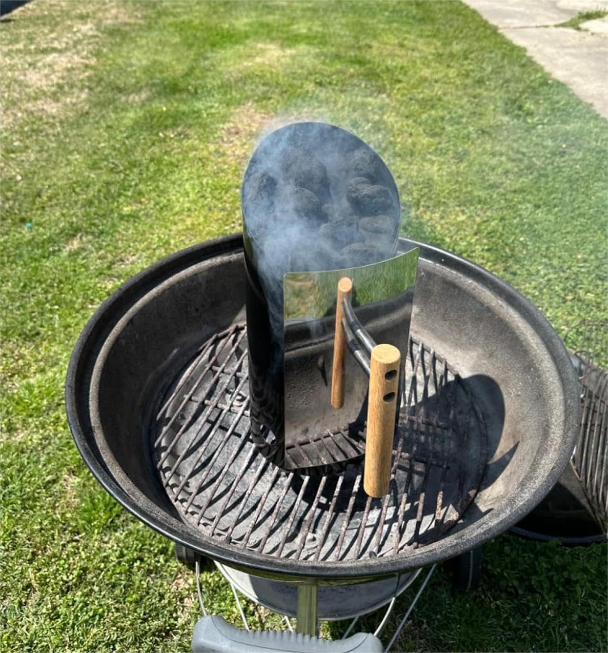 Joyagrill shovel-outlet design allows controlled charcoal dump.