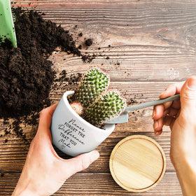 Jutasty planter with wood tray protects surfaces from water.