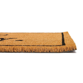 Juvale Go Away Doormat placed on porch, ideal for outdoor entrance decor.