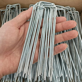 Jxrhy garden staples securing landscape fabric into the ground for stable setups.