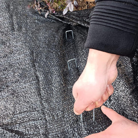 Jxrhy landscape staples securing edging, hoses, and wires outdoors.