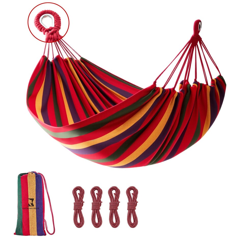 KACHUAN BEAR Rainbow Hammock setup between trees for outdoor relaxation.