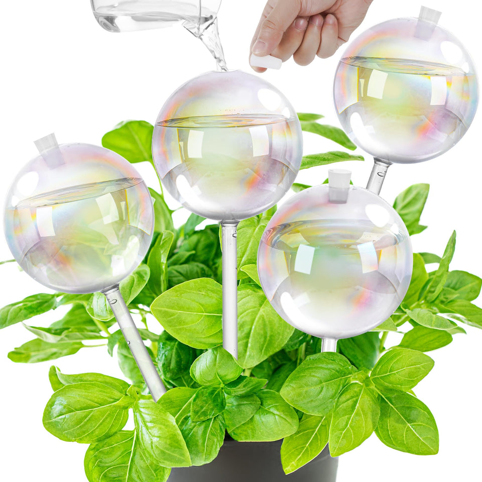 Kaimfdg 17oz watering globe resting in soil provides steady hydration for indoor plants.
