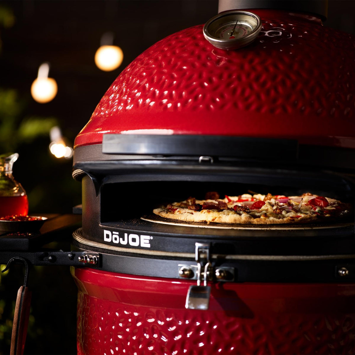 Kamado Joe DōJoe ceramic pizza stone distributes heat for crispy crusts