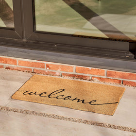 KANKUN Coco Coir Door Mat close-up bristles scraping dirt at doorstep.