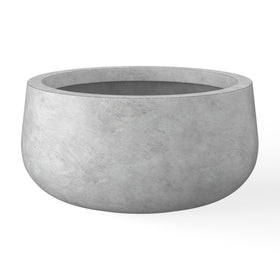 Kante round concrete planter with curved design enhances modern spaces.