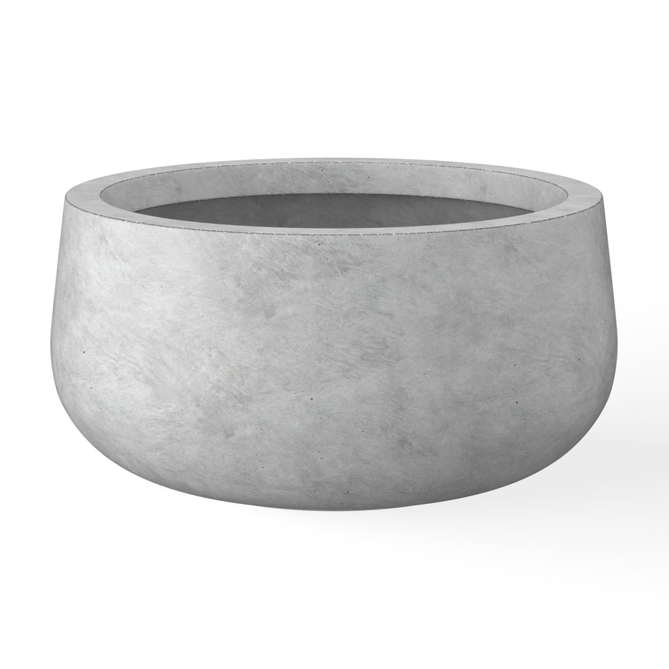 Kante round concrete planter with curved design enhances modern spaces.