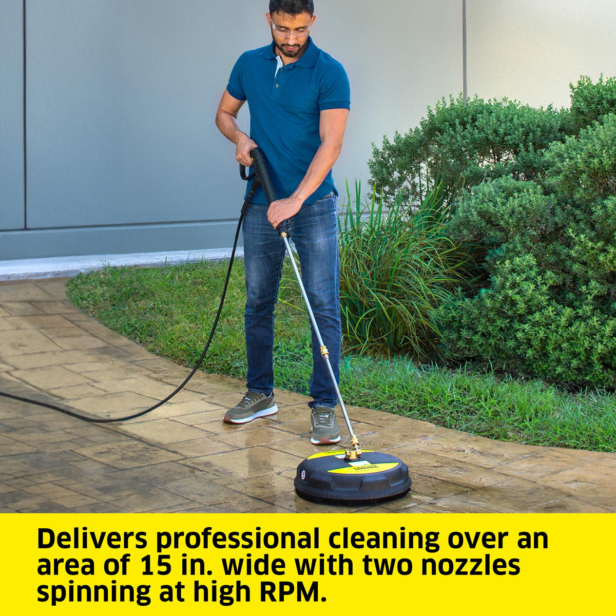 KÄRCHER surface cleaner on brick or stucco vertical surface for thorough cleaning.