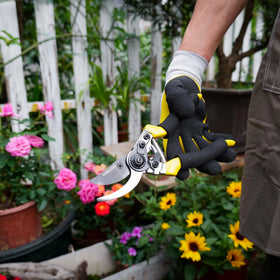 Bright yellow handles of Kemaier pruning shears for quick garden spotting.