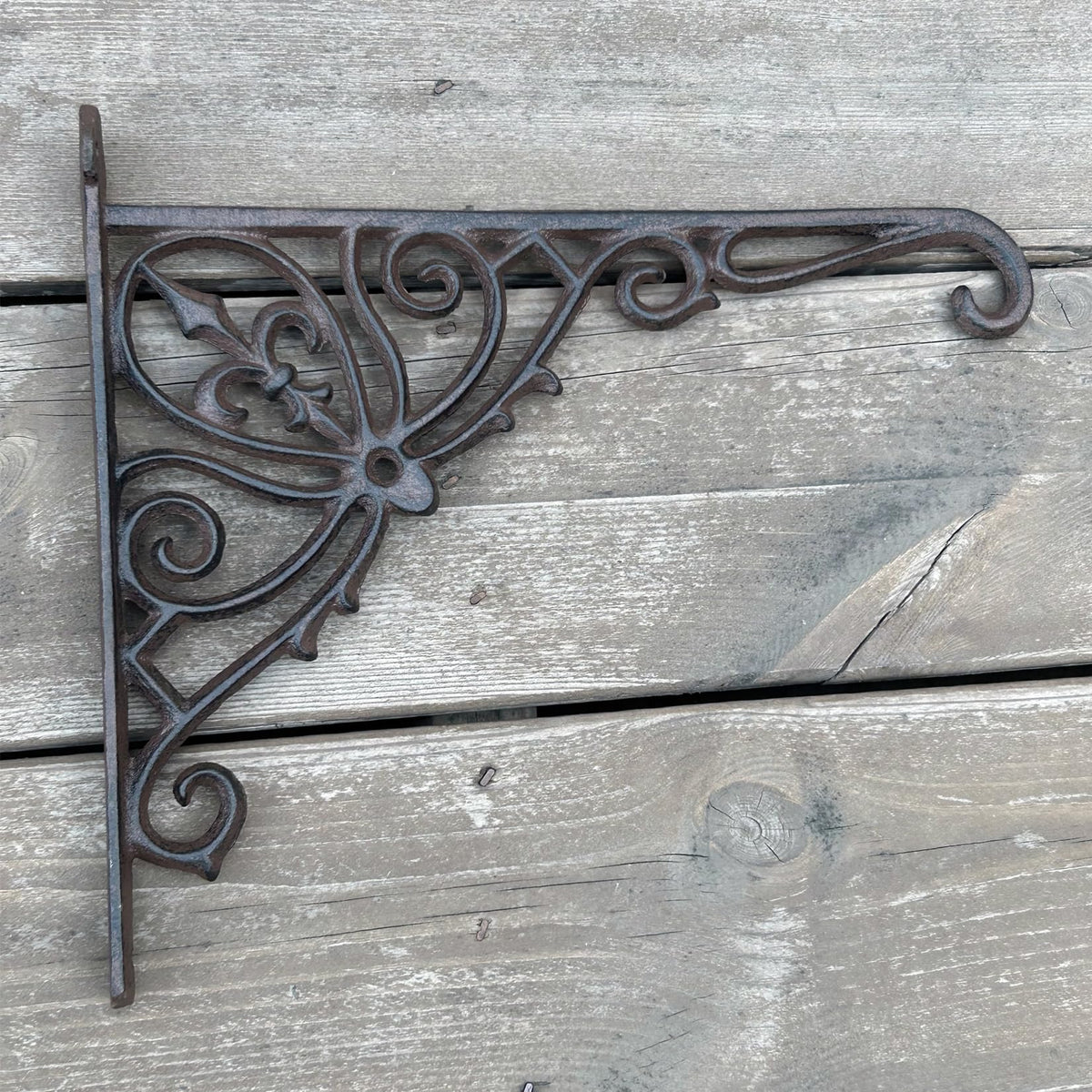 KiaoTime wrought iron bracket adds decorative charm to garden walls