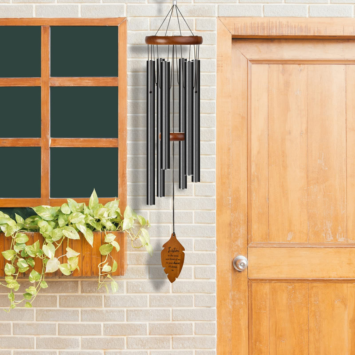 Kingtto Outdoors wind chimes hanging from tree as outdoor memorial decor.