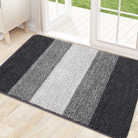 Kitinjoy door mat with absorbent dirt-trapper fibers catching mud at entryway, helping keep floors clean.