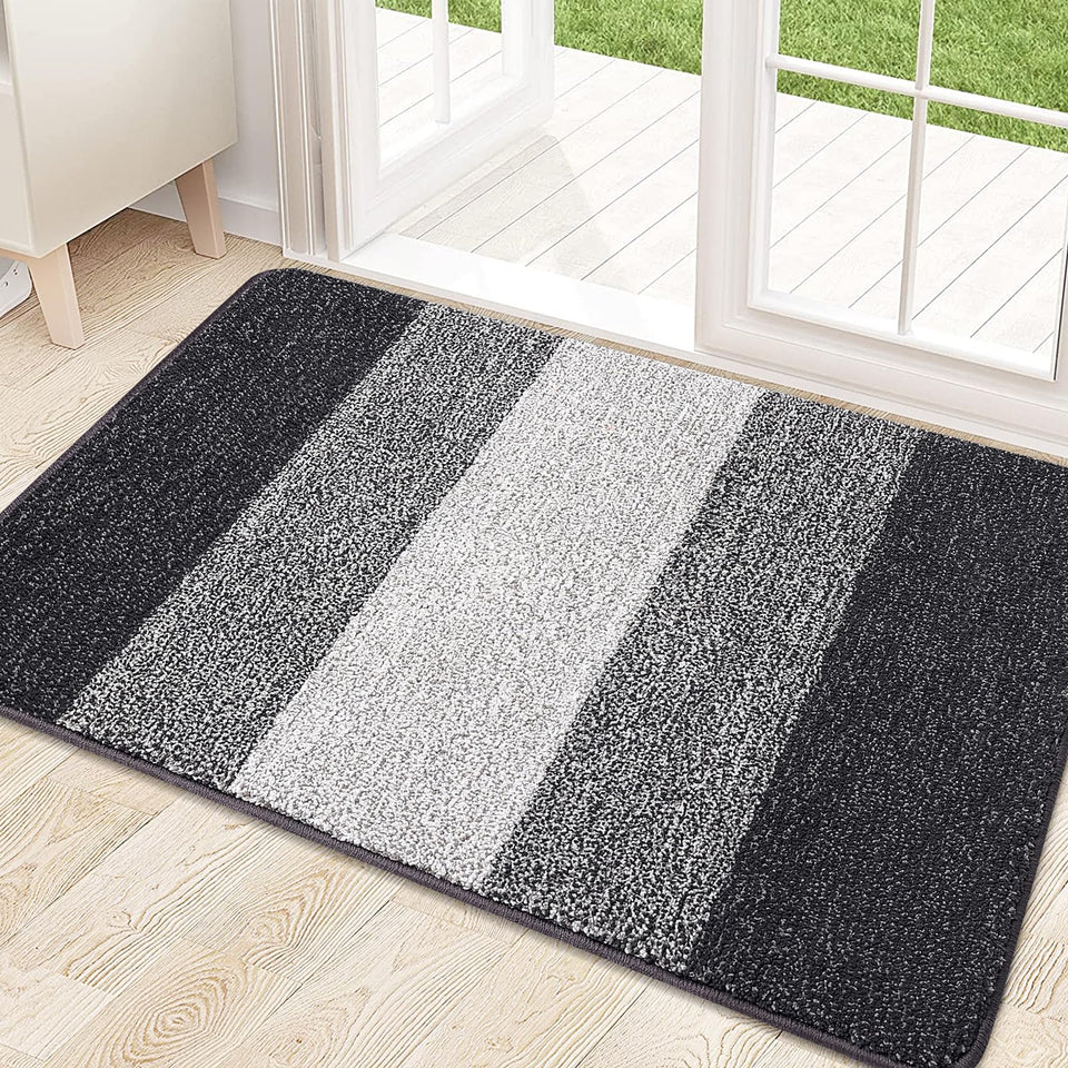 Kitinjoy door mat with absorbent dirt-trapper fibers catching mud at entryway, helping keep floors clean.