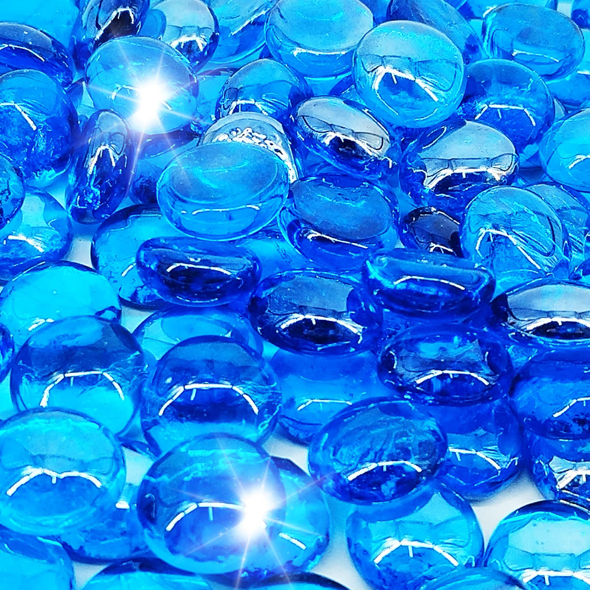 Kleuete Pacific Blue fire glass drops half-inch in a pit, adding radiant heat and ambiance.