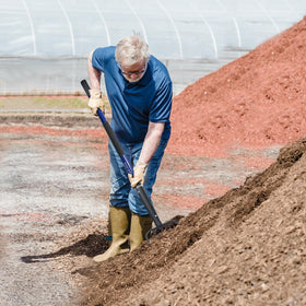 KOLEIYA pitchfork turning compost piles with ease.