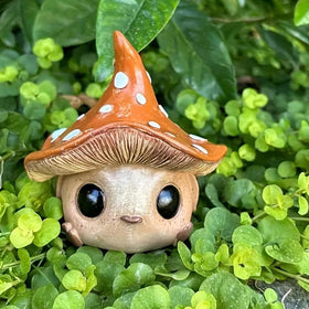 Kudriod mushroom garden statue on patio, creates magical outdoor focal point.