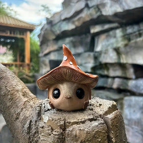 Kudriod mushroom statue, winter-ready outdoor decor, withstands seasonal weather.