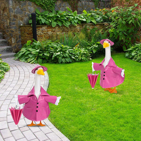 Kuscul goose hat and umbrella outfit enhancing yard decor and whimsy.