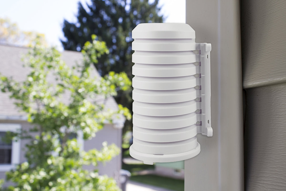 Shield installed on an outdoor sensor with built-in wire access for neat routing