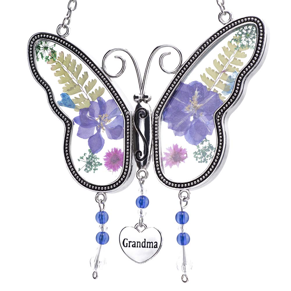Laraine butterfly suncatcher with pressed flowers brightens a sunlit window.
