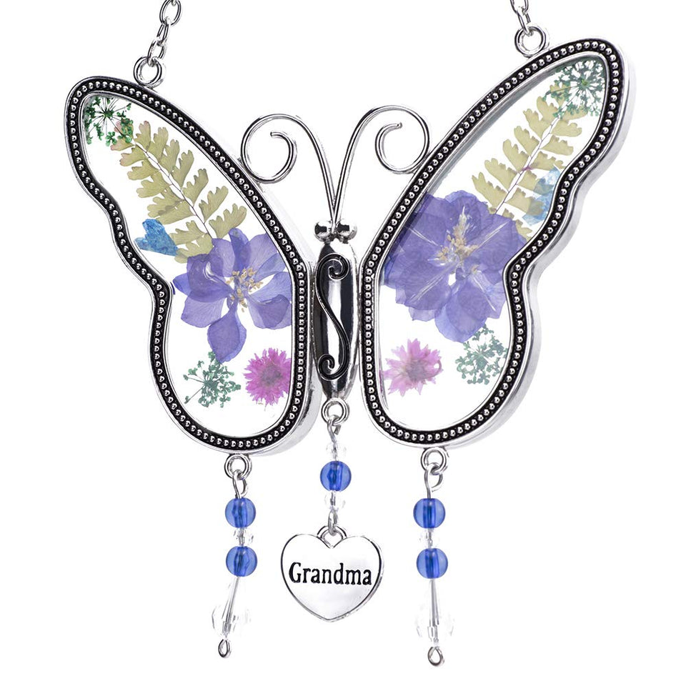 Laraine butterfly suncatcher with pressed flowers brightens a sunlit window.