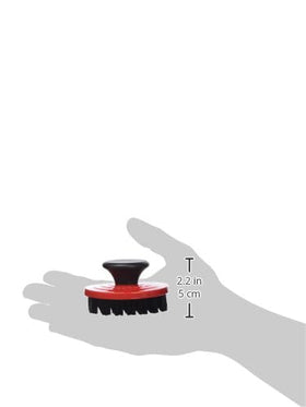Le Creuset nylon brush between ridges, dishwasher-safe for quick cleanup.