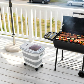 Leafory outdoor grilling setup with storage container beside a grill.