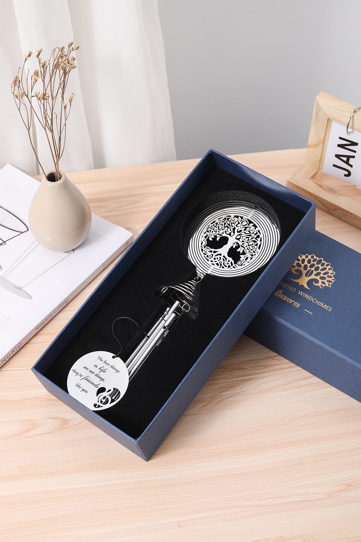 LEAVORES wind chime in a breezy garden setting with spinner dancing