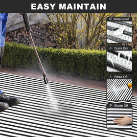 LEEVAN black and white striped rug, reversible for versatile outdoor styling.