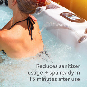 LEISURE TIME enzyme bottle beside spa water shows algae control and reduced maintenance needs.