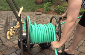 Liberty Garden bronze finish hose cart with pneumatic tires rolls smoothly on rough ground