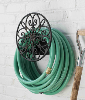 Liberty Garden hose butler bronze finish stores up to 125 feet of hose when not in use.