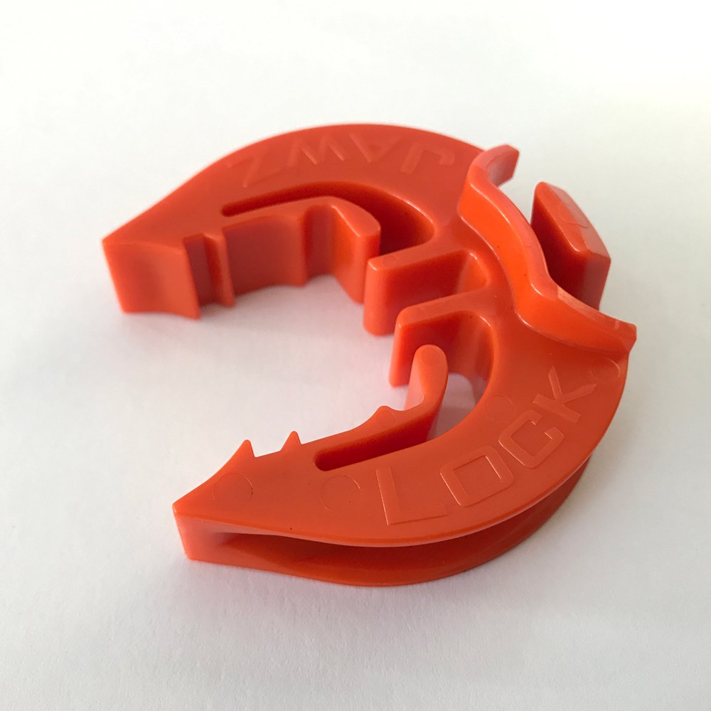 Bright orange LockJawz insulator stands out for quick fence checks