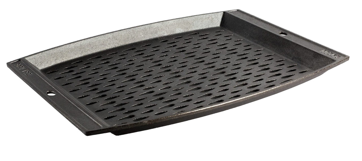 Lodge grill topper on a hot grill showing a large surface to keep food contained.
