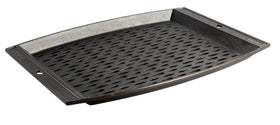 Lodge grill topper on a hot grill showing a large surface to keep food contained.