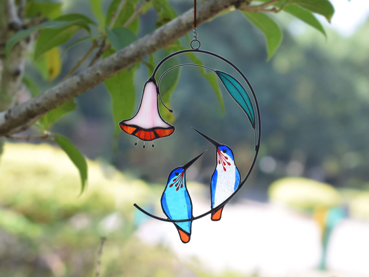 Lolitarcrafts blue hummingbird suncatcher reflects light for a colorful shimmer.