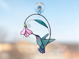 Lolitarcrafts stained glass hummingbird window hanging on a sunny window