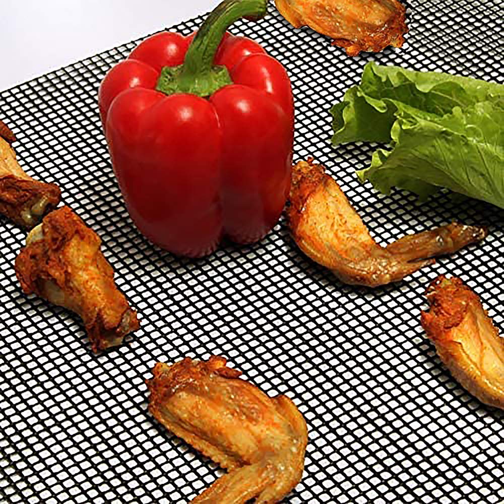 LOOCH BBQ Mesh Grill Mats being scrubbed for easy cleaning