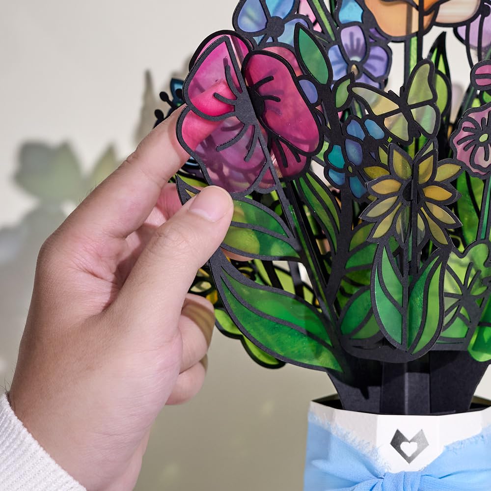 Daisies glow warmly, a Lovepop Garden Glow Suncatcher up close