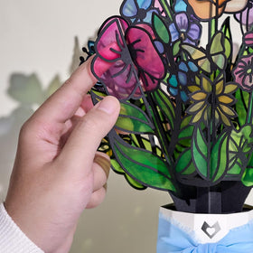 Daisies glow warmly, a Lovepop Garden Glow Suncatcher up close