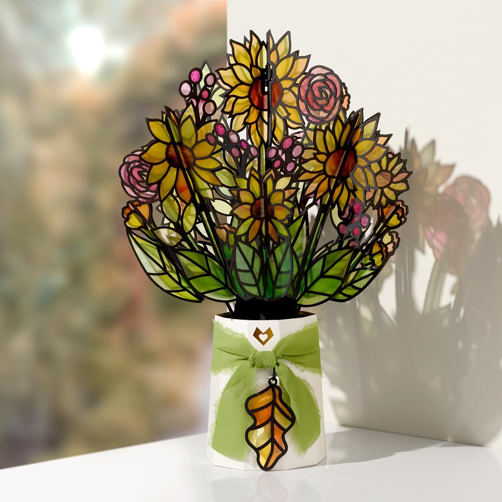Lovepop sunflower pop-up bouquet enhances a windowsill with warm color and dancing shadows.