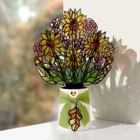 Lovepop sunflower pop-up bouquet enhances a windowsill with warm color and dancing shadows.