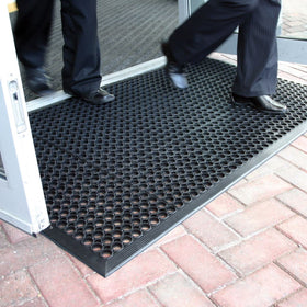 Lovinland large doormat at entrance with holes to scrape dirt.