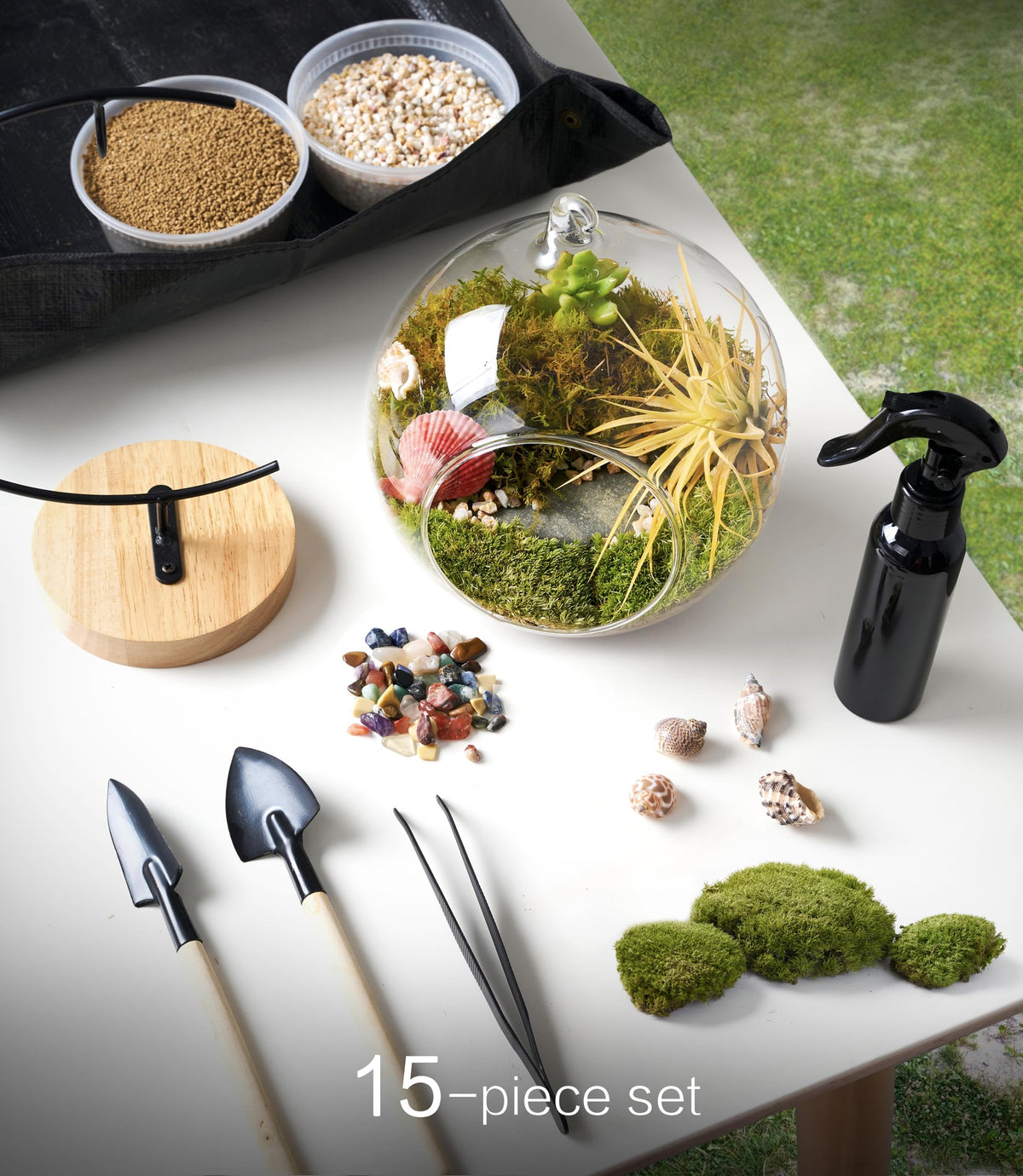 LUCKYRUNES sprayer and tools enable easy DIY terrarium assembly on a desk.